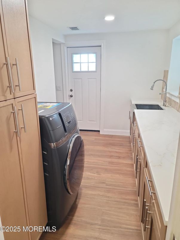 Interior, Kitchen, Recessed Lighting, Washer, Wood Texture Flooring