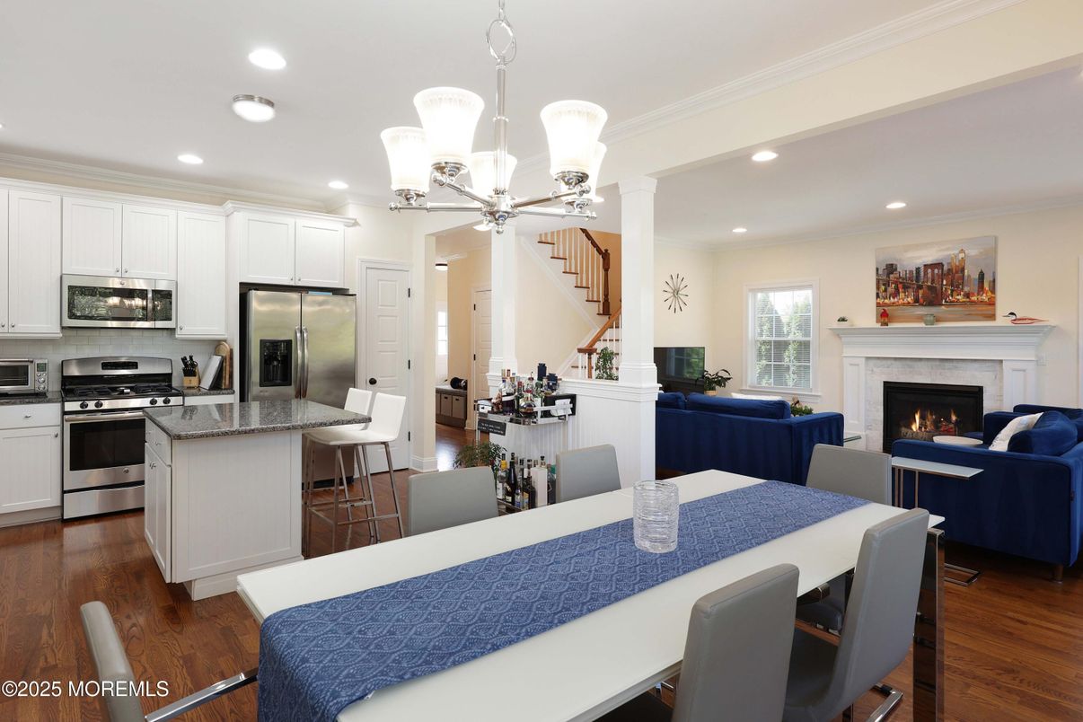 Chandelier, Dining room, Fireplace, Interior, Kitchen, Living room, Recessed Lighting, Stainless Steel Appliances, Wood Texture Flooring