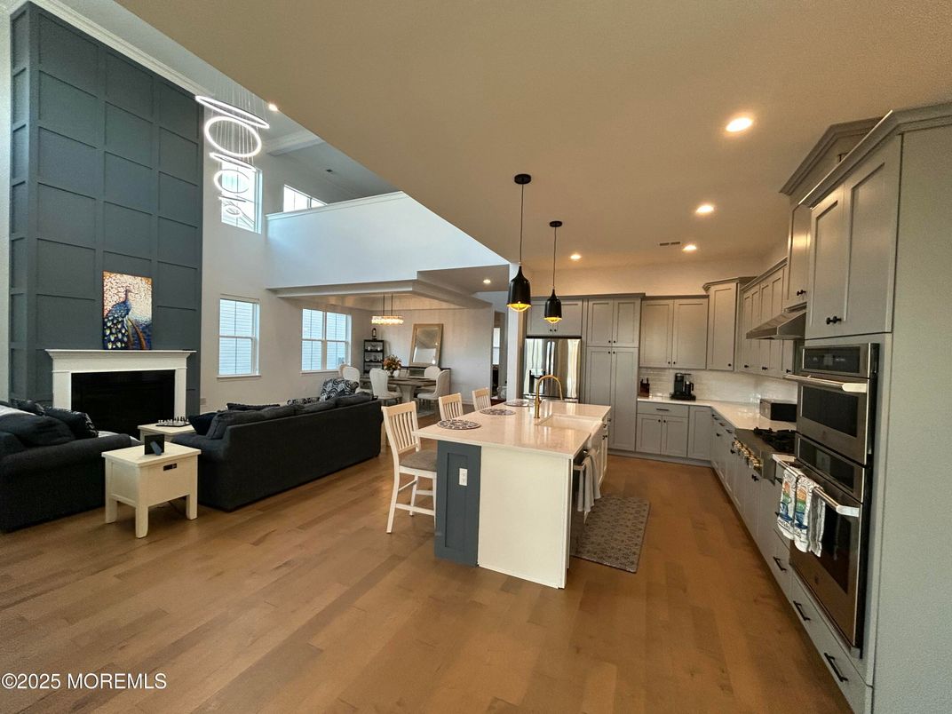 Fireplace, Interior, Kitchen, Living room, Pendant Lights, Recessed Lighting, Stainless Steel Appliances, Wood Texture Flooring