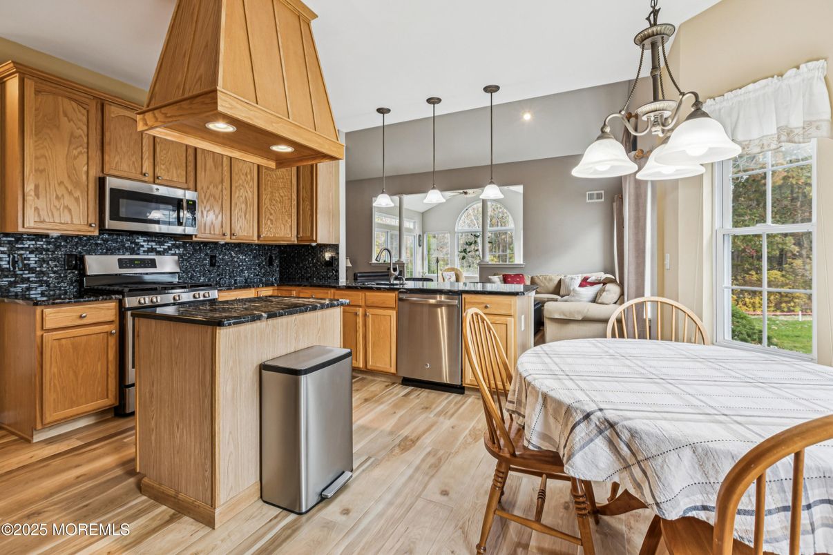 Dining room, Interior, Kitchen, Pendant Lights, Recessed Lighting, Stainless Steel Appliances, Wood Texture Flooring