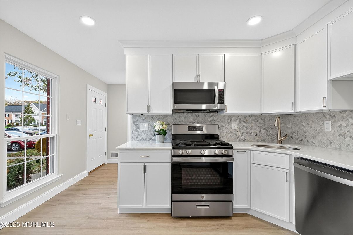 Interior, Kitchen, Marble Walls, Recessed Lighting, Stainless Steel Appliances, Wood Texture Flooring