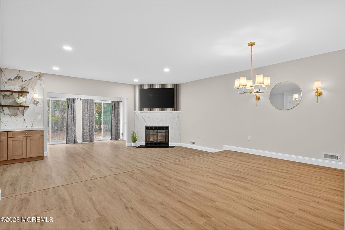 Chandelier, Empty room, Fireplace, Interior, Recessed Lighting, Wood Texture Flooring