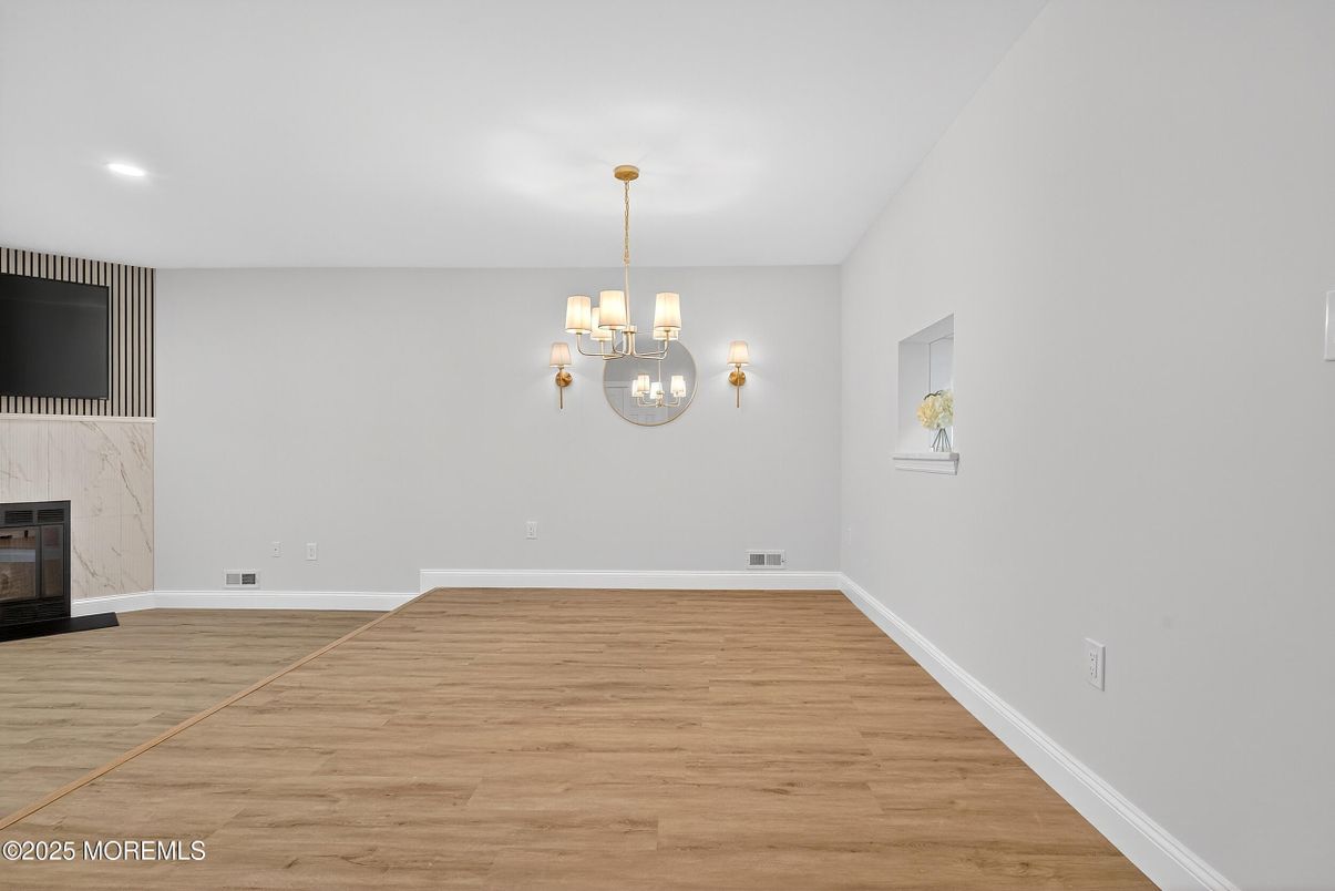 Chandelier, Empty room, Fireplace, Interior, Recessed Lighting, Wood Texture Flooring