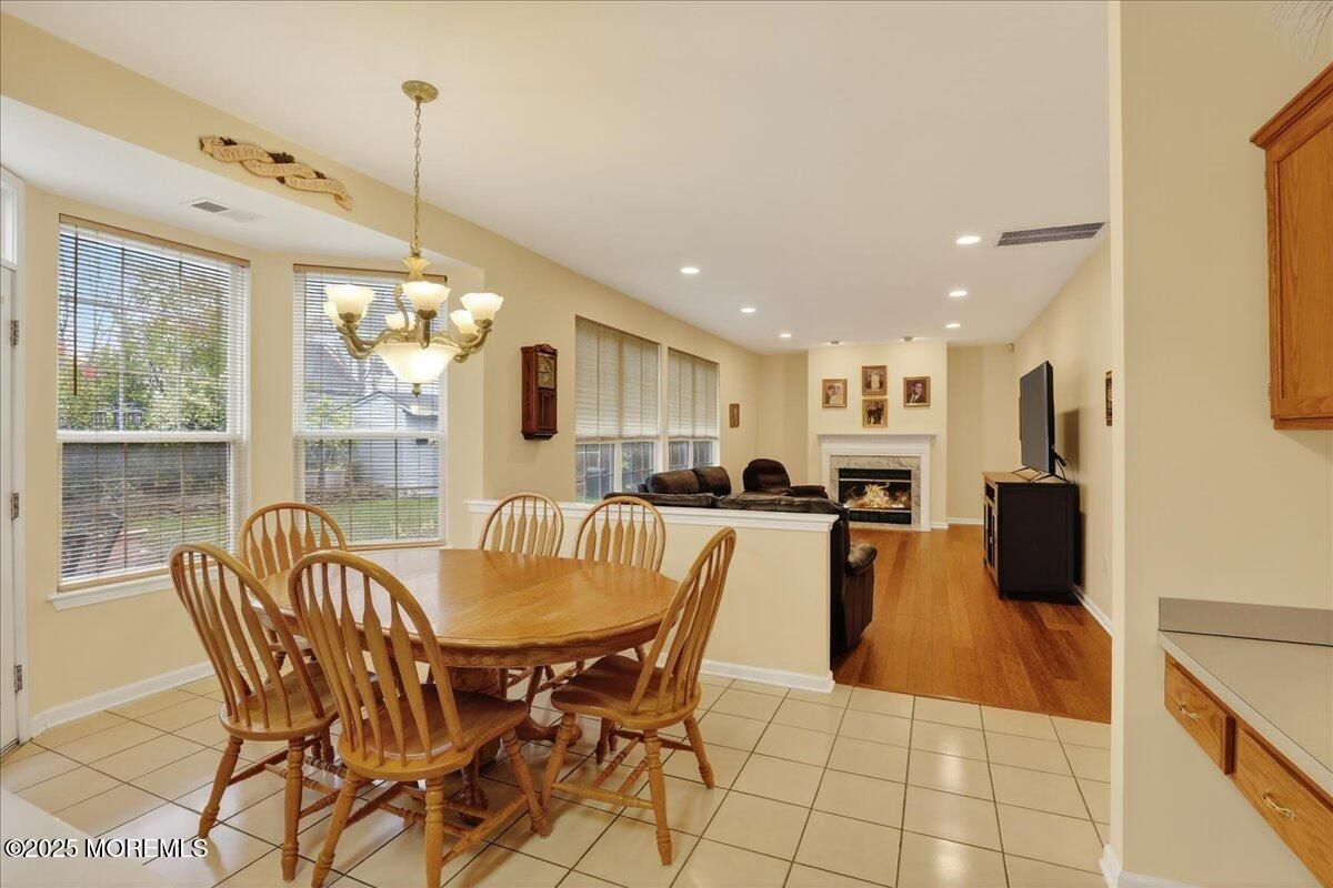 Chandelier, Dining room, Fireplace, Interior, Living room, Pendant Lights, Recessed Lighting, Wood Texture Flooring