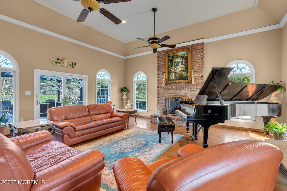 Fireplace, Interior, Living room, Piano, Recessed Lighting, Stone Walls, Wood Texture Flooring