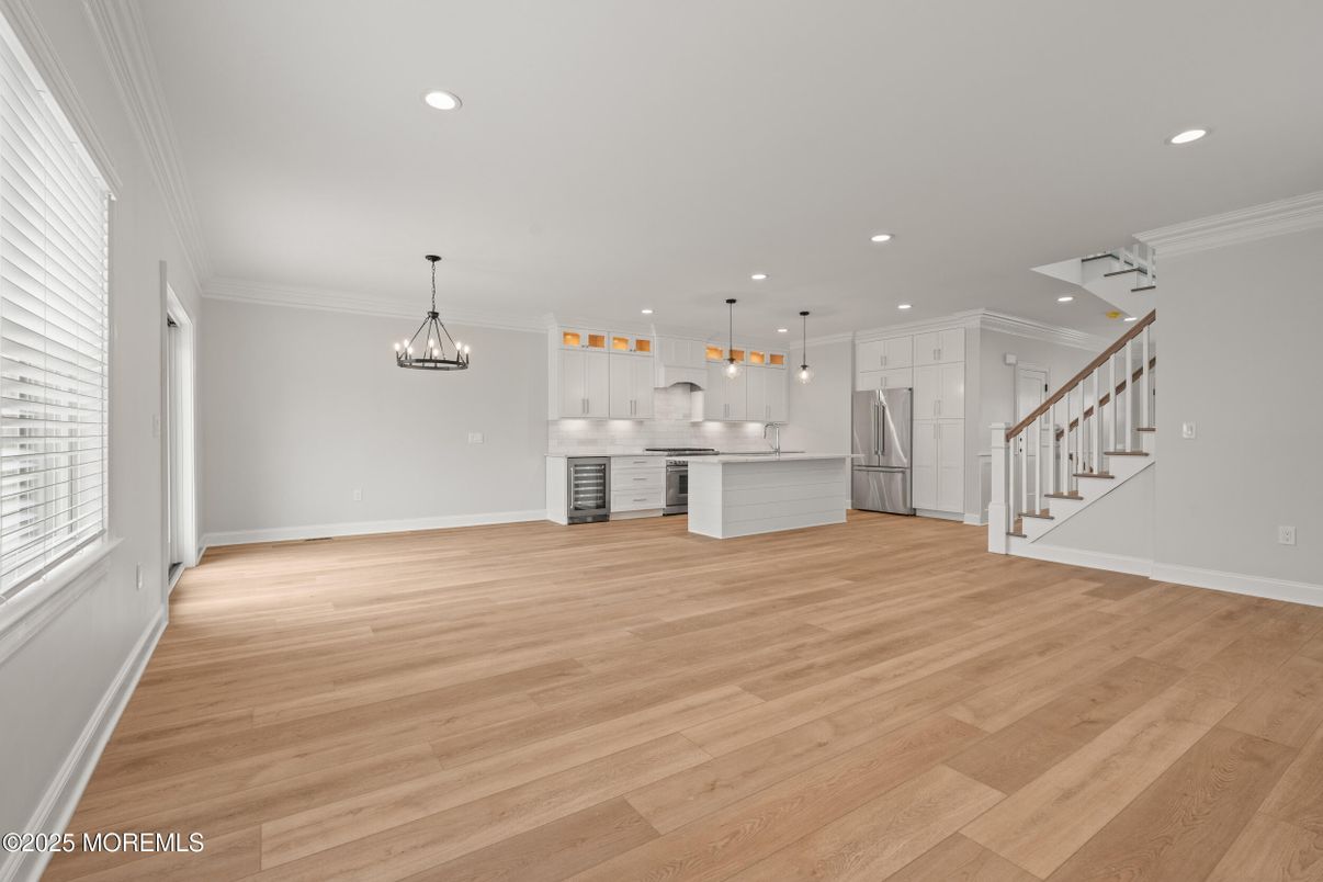 Chandelier, Empty room, Interior, Kitchen, Pendant Lights, Recessed Lighting, Stainless Steel Appliances, Wood Texture Flooring