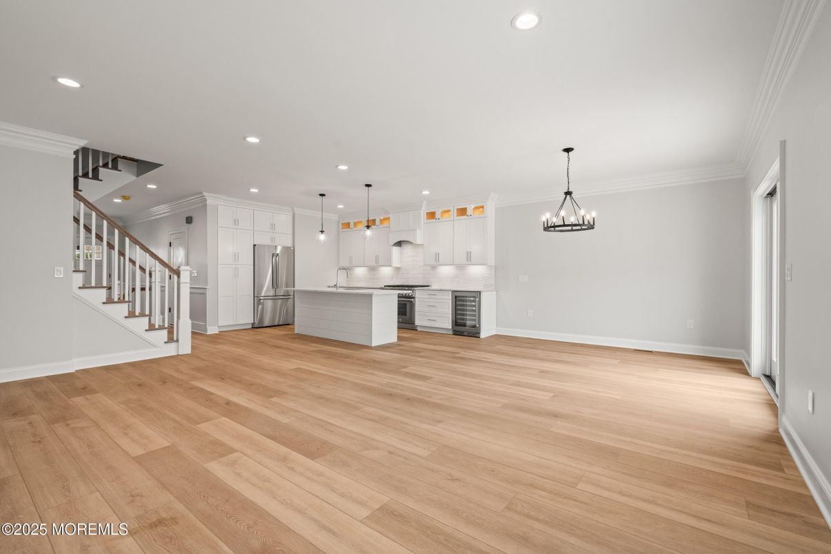 Empty room, Interior, Kitchen, Pendant Lights, Recessed Lighting, Stainless Steel Appliances, Wood Texture Flooring