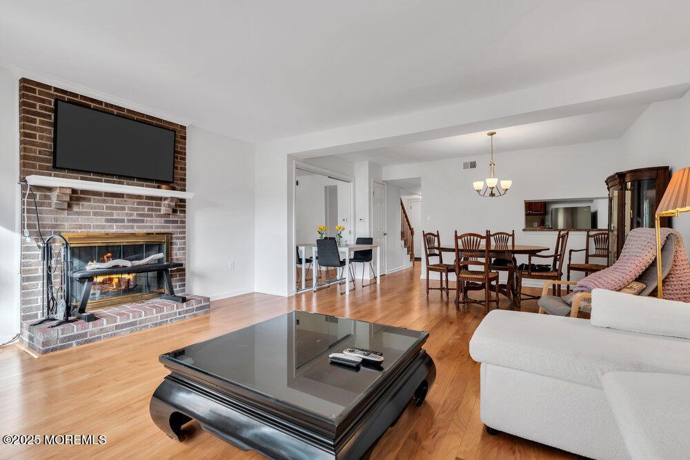 Chandelier, Dining room, Fireplace, Interior, Living room, Stone Walls, Wood Texture Flooring