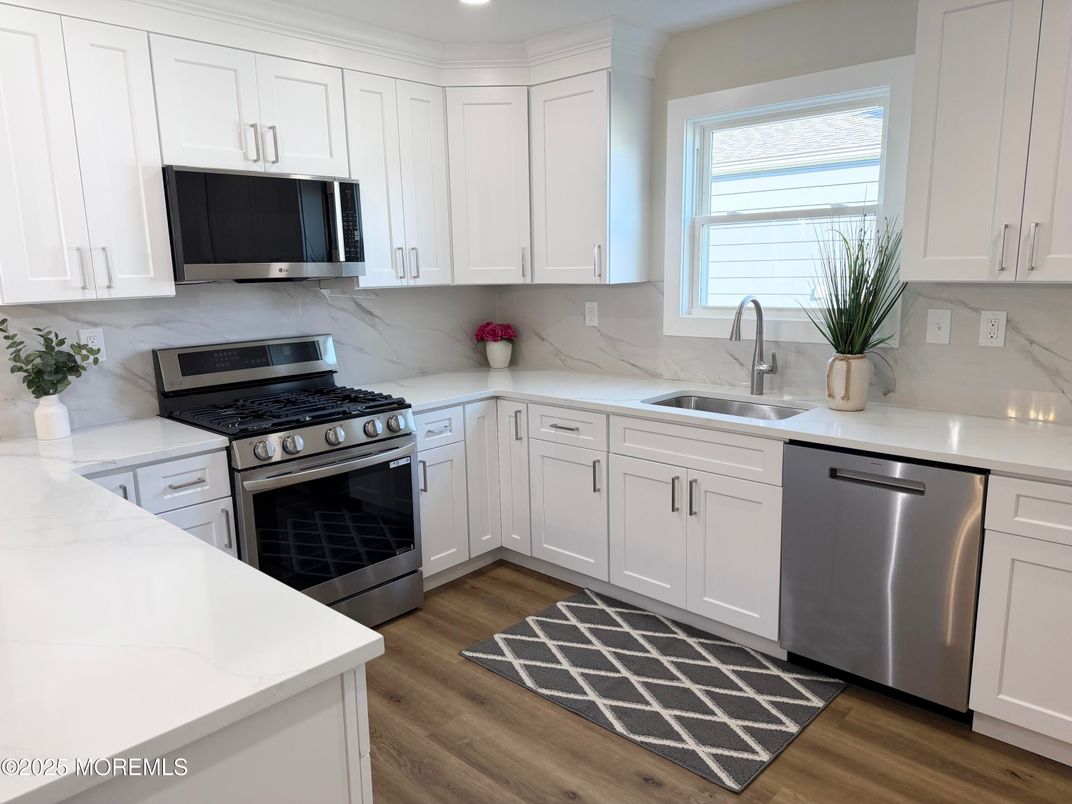 Interior, Kitchen, Marble Walls, Recessed Lighting, Stainless Steel Appliances, Wood Texture Flooring