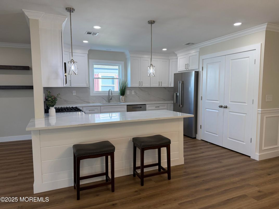 Interior, Kitchen, Marble Walls, Pendant Lights, Recessed Lighting, Stainless Steel Appliances, Wood Texture Flooring