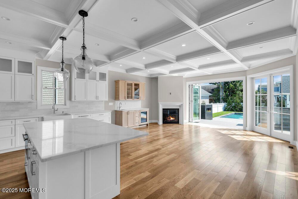 Empty room, Fireplace, Interior, Kitchen, Pendant Lights, Recessed Lighting, Wood Texture Flooring