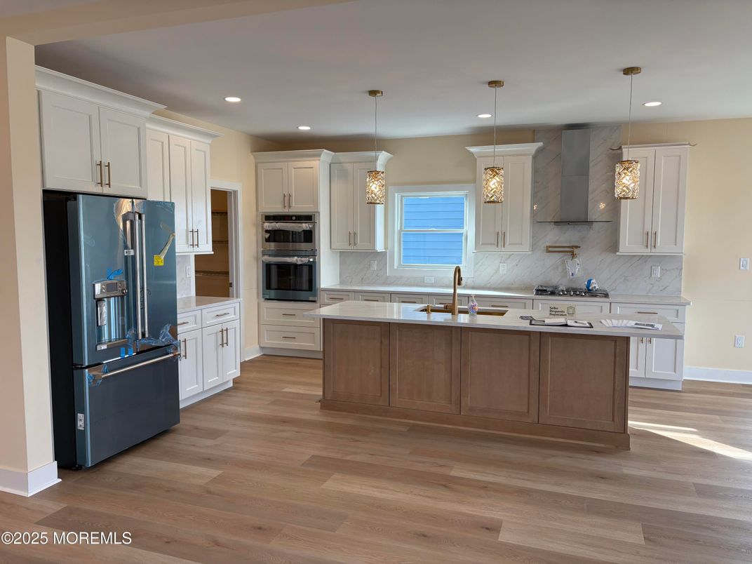 Interior, Kitchen, Marble Walls, Pendant Lights, Recessed Lighting, Stainless Steel Appliances, Wood Texture Flooring