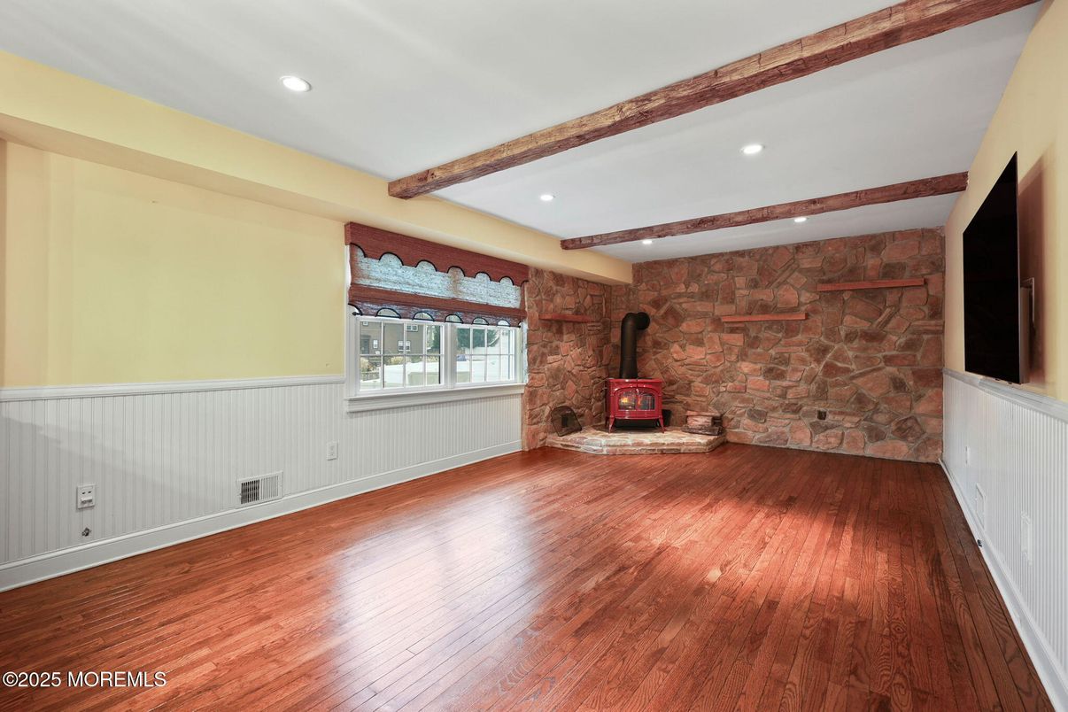 Empty room, Fireplace, Interior, Recessed Lighting, Stone Walls, Wooden Beams, Wood Texture Flooring