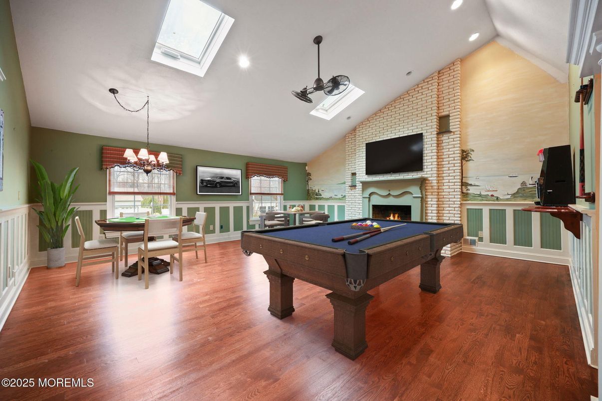 Billiard Table, Chandelier, Dining room, Fireplace, Game Room, Interior, Recessed Lighting, Stone Walls, Wood Texture Flooring