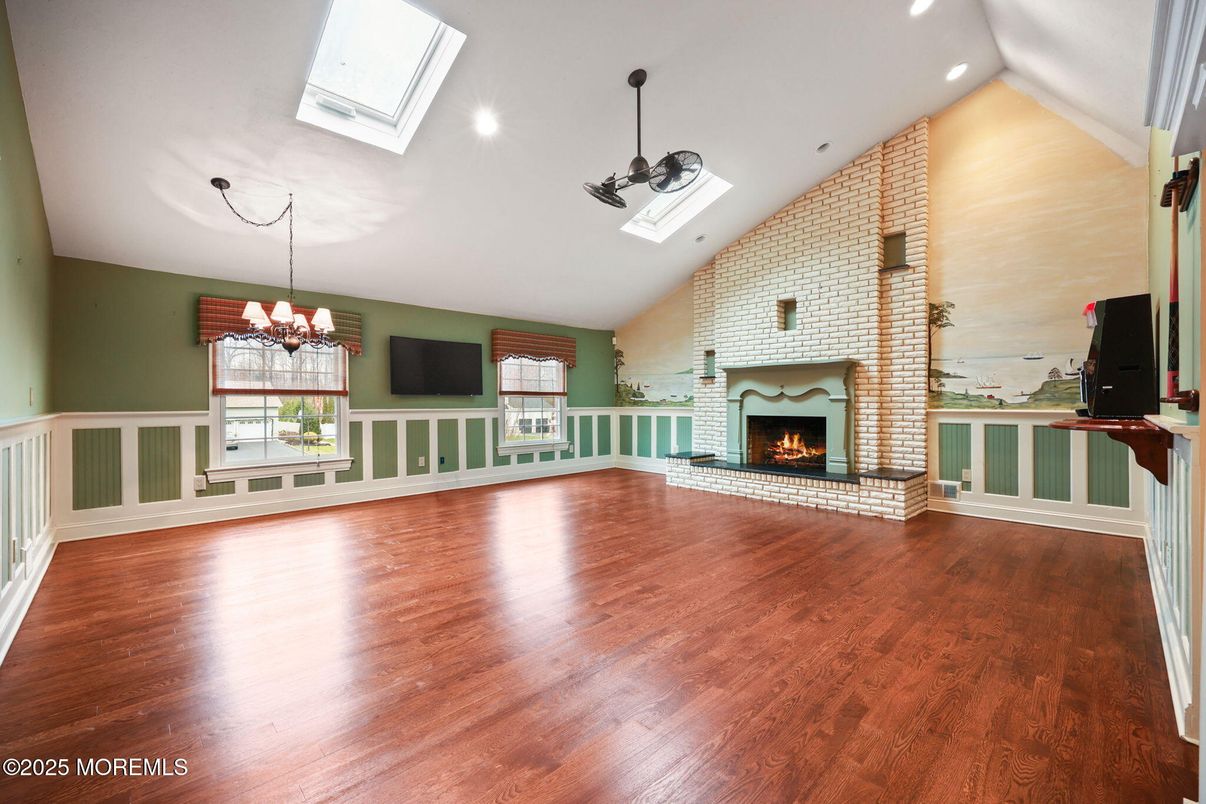 Chandelier, Empty room, Fireplace, Interior, Recessed Lighting, Stone Walls, Wood Texture Flooring