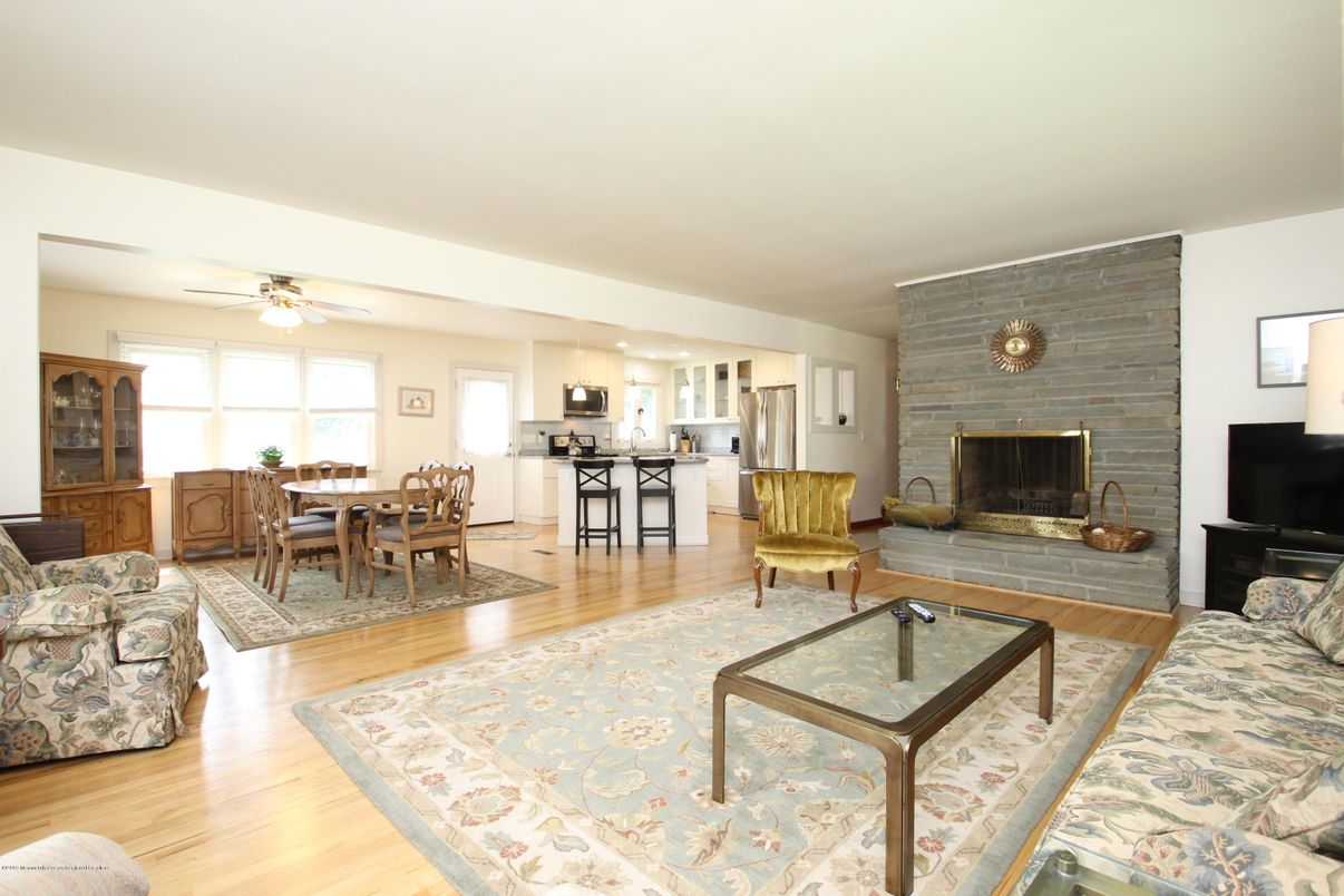 Dining room, Fireplace, Interior, Kitchen, Living room, Pendant Lights, Stainless Steel Appliances, Stone Walls, Wood Texture Flooring