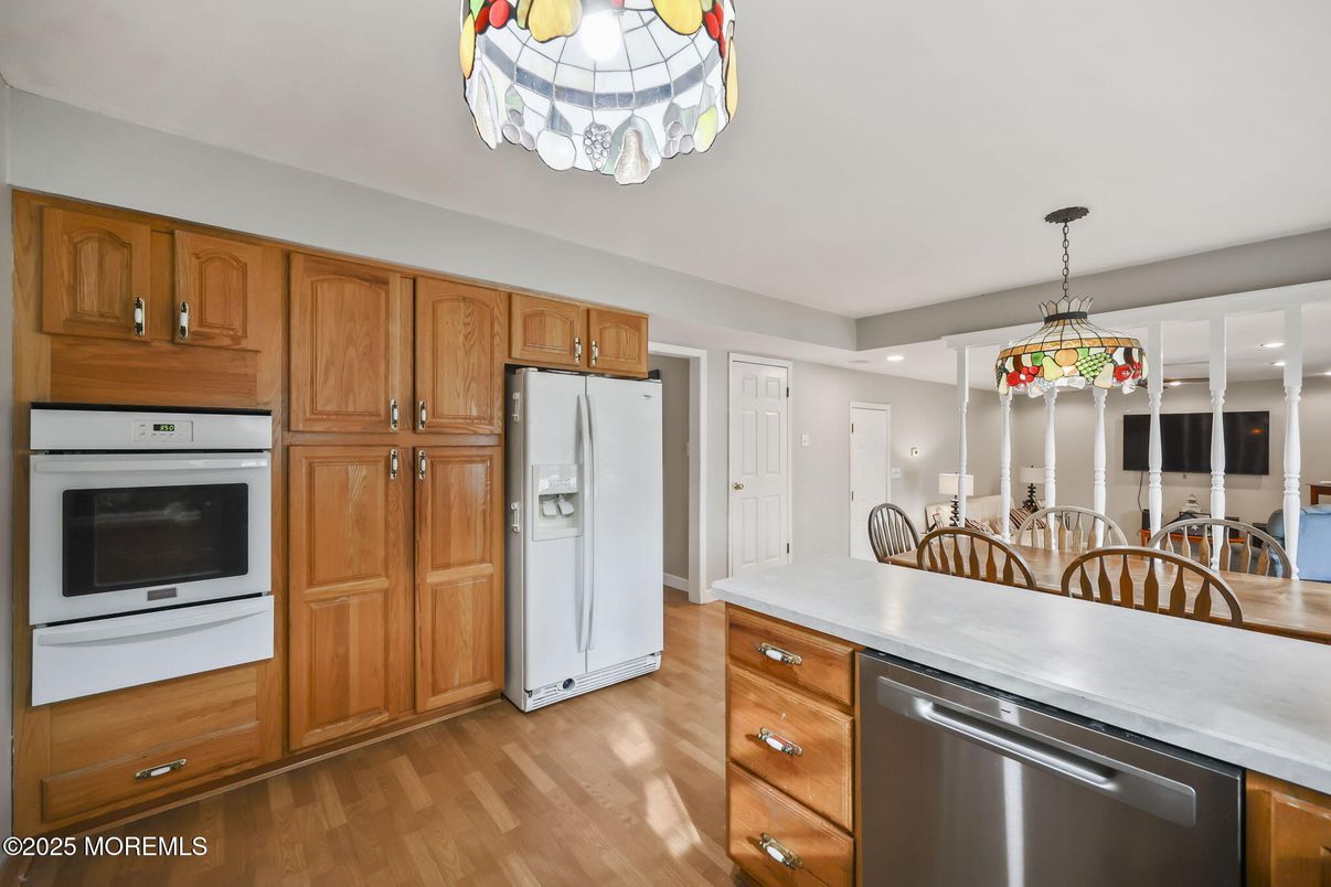 Dining room, Interior, Kitchen, Pendant Lights, Recessed Lighting, Stainless Steel Appliances, Wood Texture Flooring