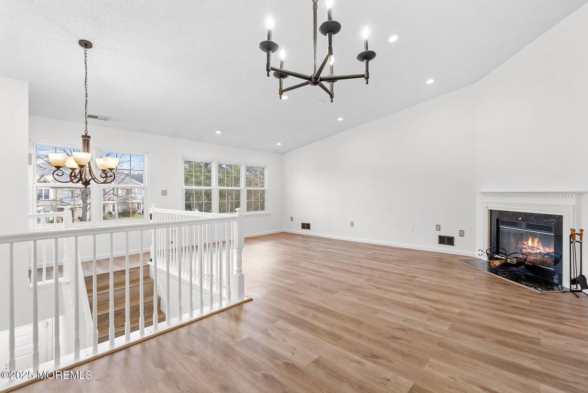 Chandelier, Empty room, Fireplace, Interior, Recessed Lighting, Wood Texture Flooring