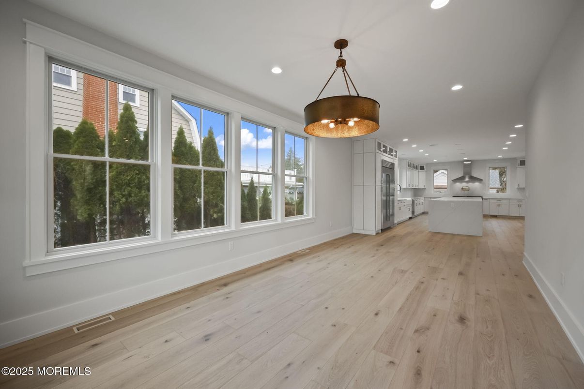 Empty room, Interior, Kitchen, Pendant Lights, Recessed Lighting, Stainless Steel Appliances, Wood Texture Flooring