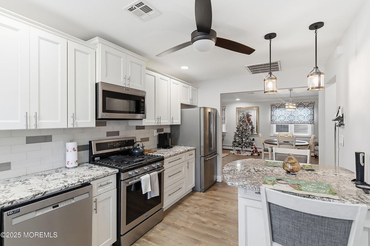 Dining room, Interior, Kitchen, Pendant Lights, Recessed Lighting, Stainless Steel Appliances, Wood Texture Flooring