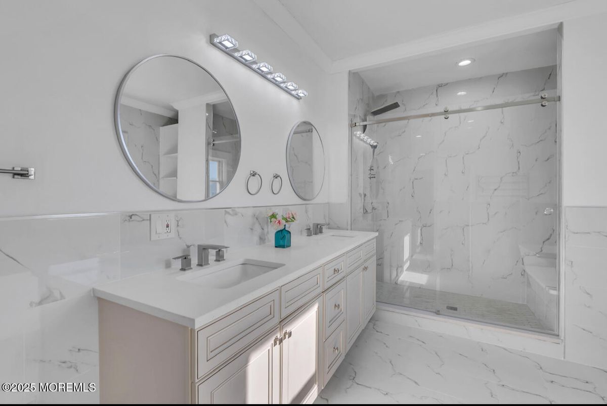 Bathroom, Dual Sink Vanities, Glass Shower, Interior, Marble, Marble Walls, Recessed Lighting