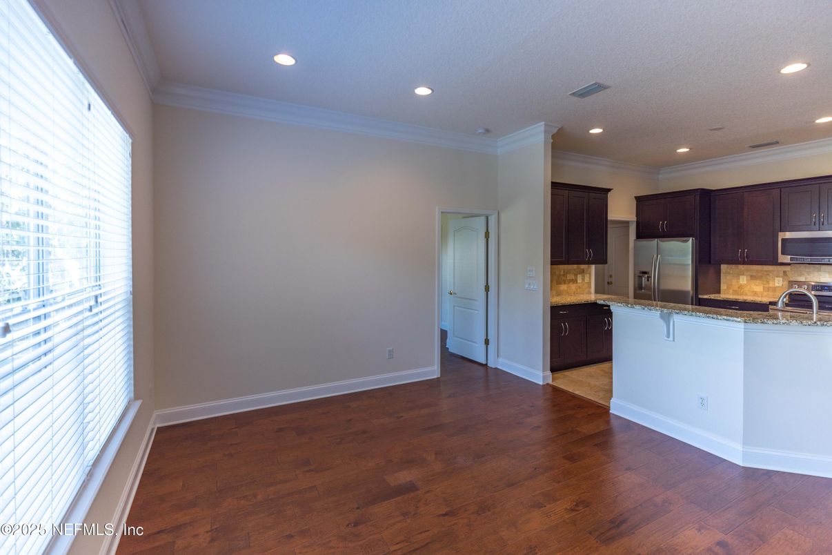 Empty room, Interior, Kitchen, Recessed Lighting, Stainless Steel Appliances, Wood Texture Flooring