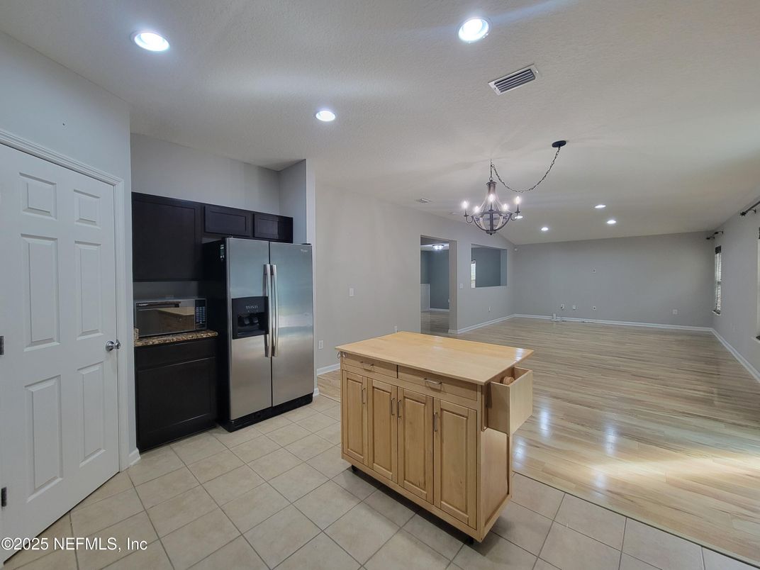 Chandelier, Empty room, Interior, Kitchen, Recessed Lighting, Stainless Steel Appliances, Wood Texture Flooring