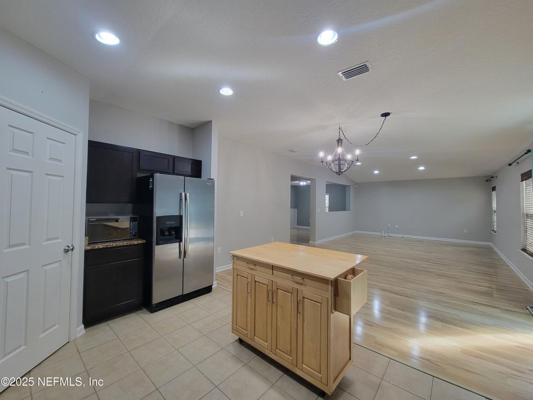 Chandelier, Empty room, Interior, Kitchen, Recessed Lighting, Stainless Steel Appliances, Wood Texture Flooring