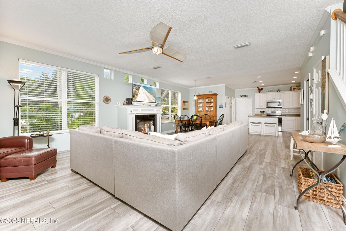 Dining room, Fireplace, Interior, Kitchen, Living room, Recessed Lighting, Stainless Steel Appliances, Wood Texture Flooring