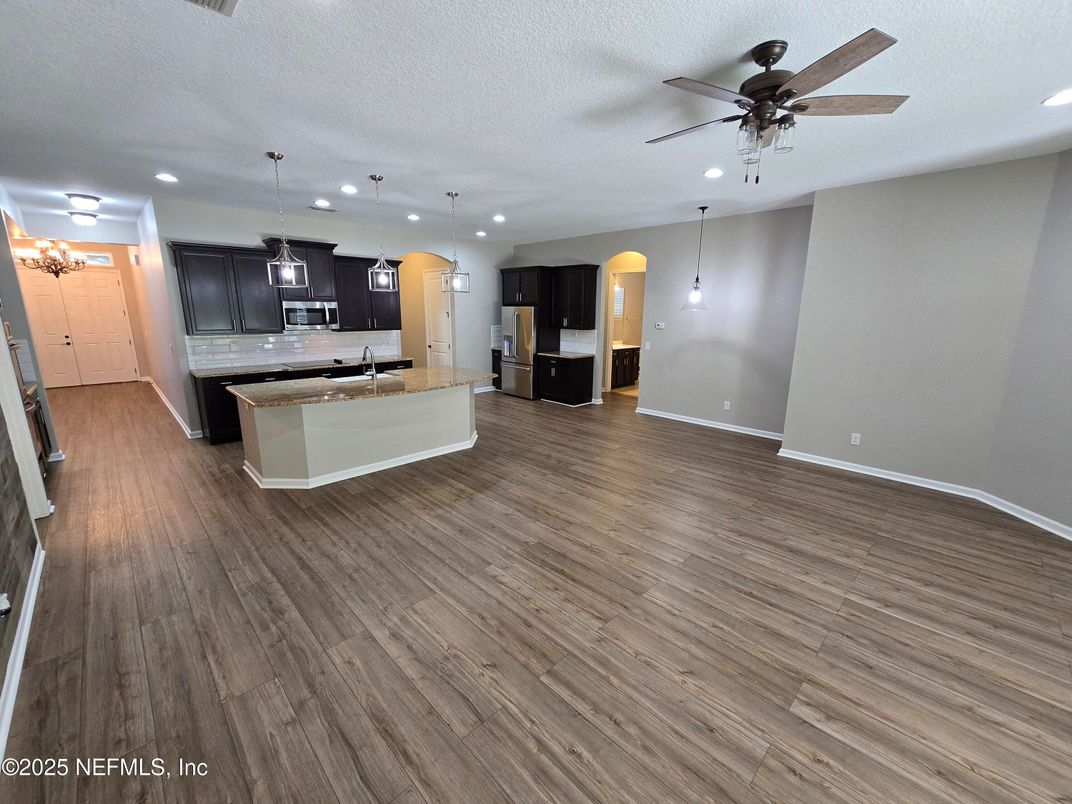 Empty room, Interior, Kitchen, Pendant Lights, Recessed Lighting, Stainless Steel Appliances, Wood Texture Flooring