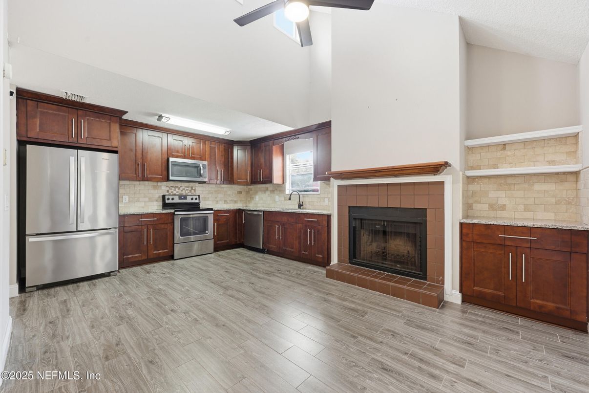 Fireplace, Interior, Kitchen, Stainless Steel Appliances, Wood Texture Flooring