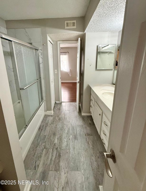 Bathroom, Dual Sink Vanities, Glass Shower, Interior, Marble Walls, Wood Texture Flooring