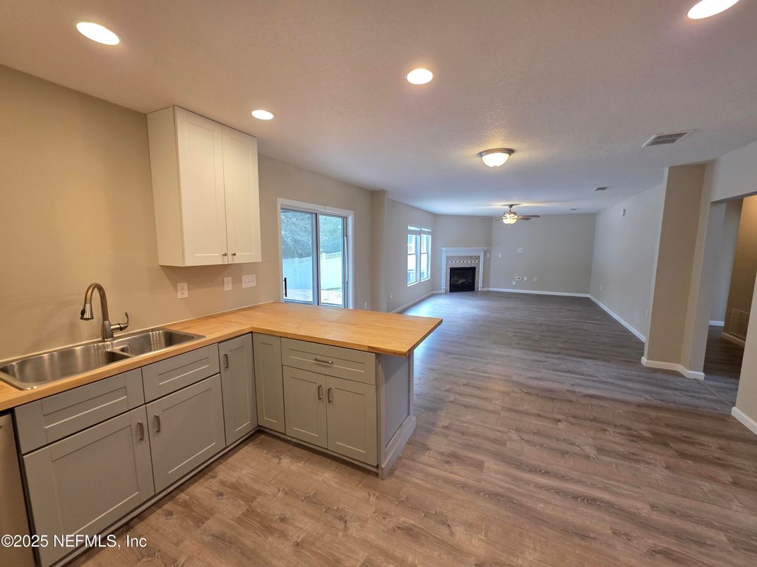 Empty room, Fireplace, Interior, Kitchen, Recessed Lighting, Wood Texture Flooring