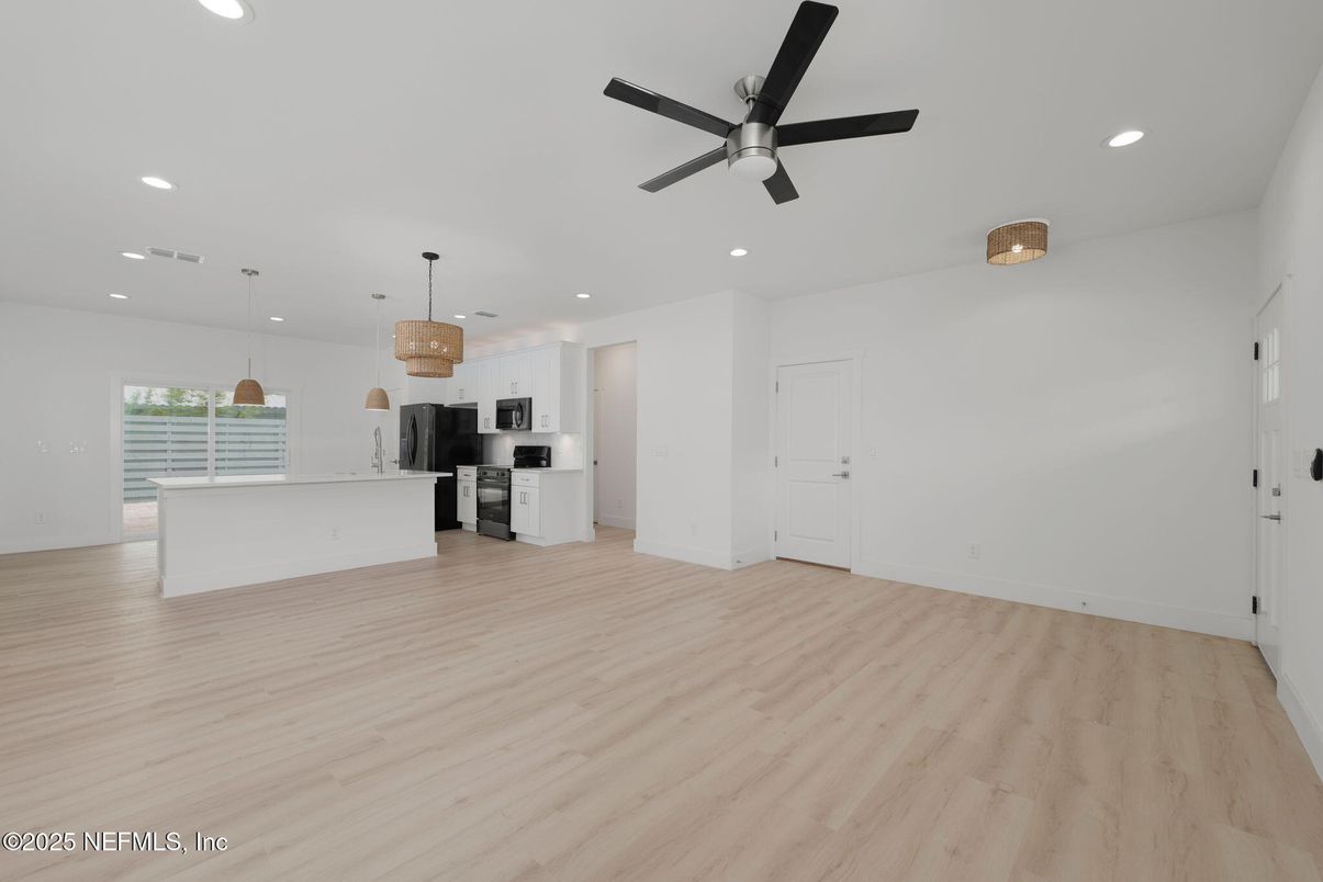 Empty room, Interior, Kitchen, Pendant Lights, Recessed Lighting, Stainless Steel Appliances, Wood Texture Flooring