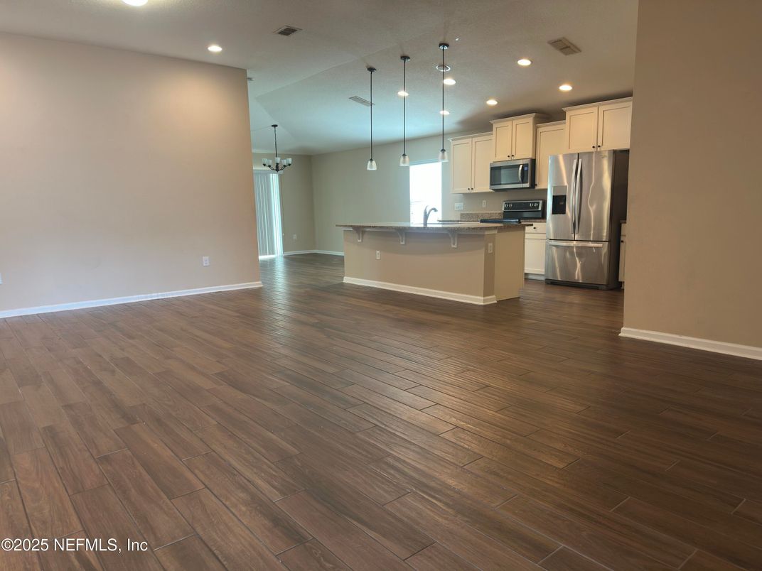 Empty room, Interior, Kitchen, Pendant Lights, Recessed Lighting, Stainless Steel Appliances, Wood Texture Flooring
