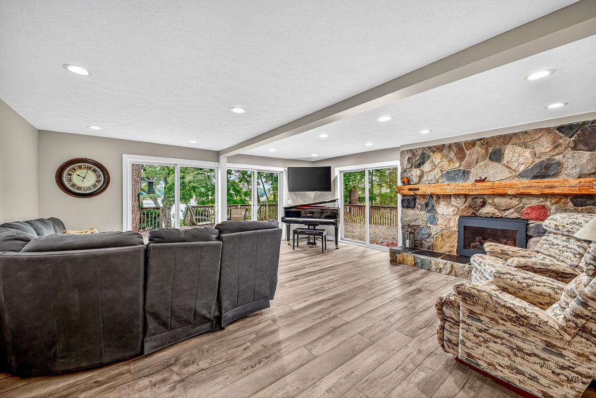 Fireplace, Interior, Living room, Piano, Recessed Lighting, Stone Walls, Wood Texture Flooring