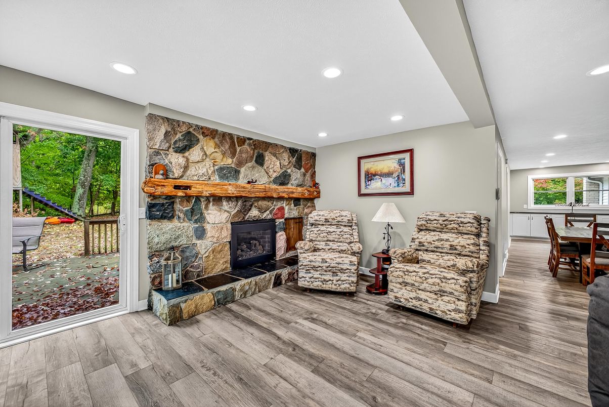 Dining room, Fireplace, Interior, Recessed Lighting, Stone Walls, Wood Texture Flooring