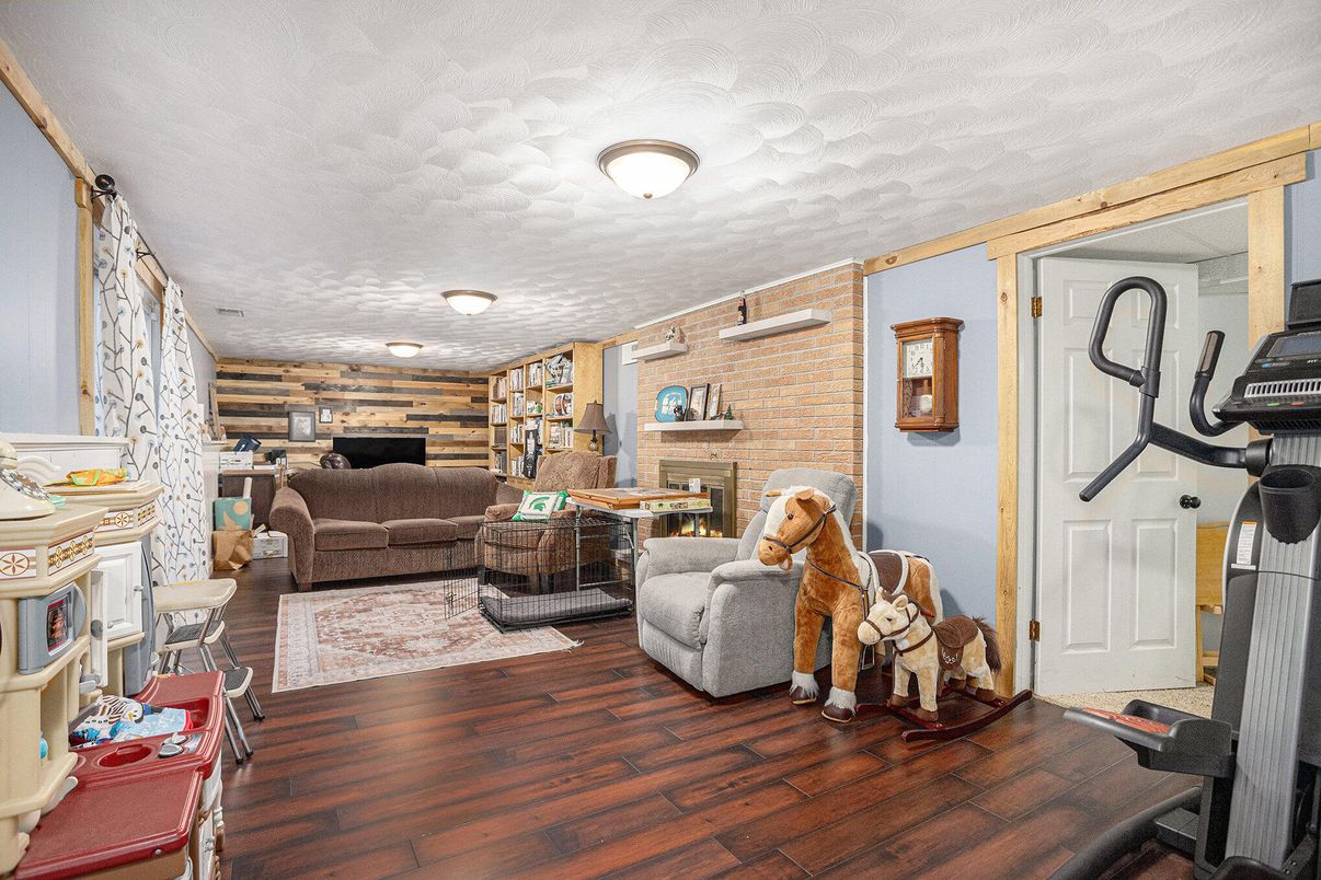 Fireplace, Fitness Equipment, Interior, Living room, Stone Walls, Wood Texture Flooring, Wooden Walls