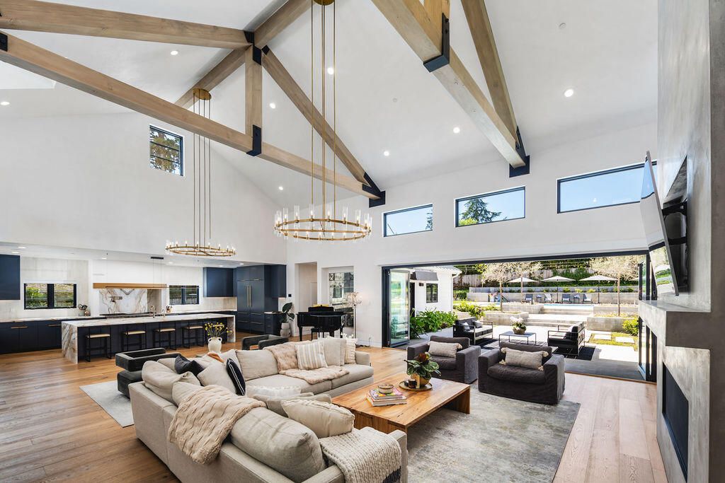 Chandelier, Fireplace, Interior, Kitchen, Living room, Pendant Lights, Piano, Recessed Lighting, Stainless Steel Appliances, Wooden Beams, Wood Texture Flooring