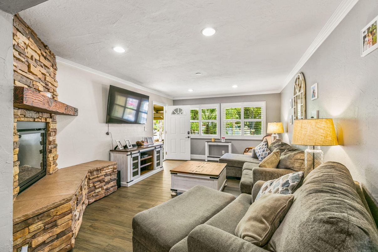 Fireplace, Interior, Living room, Recessed Lighting, Stone Walls, Wood Texture Flooring