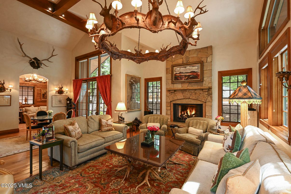 Chandelier, Dining room, Fireplace, Interior, Living room, Recessed Lighting, Stone Walls, Wooden Beams, Wood Texture Flooring