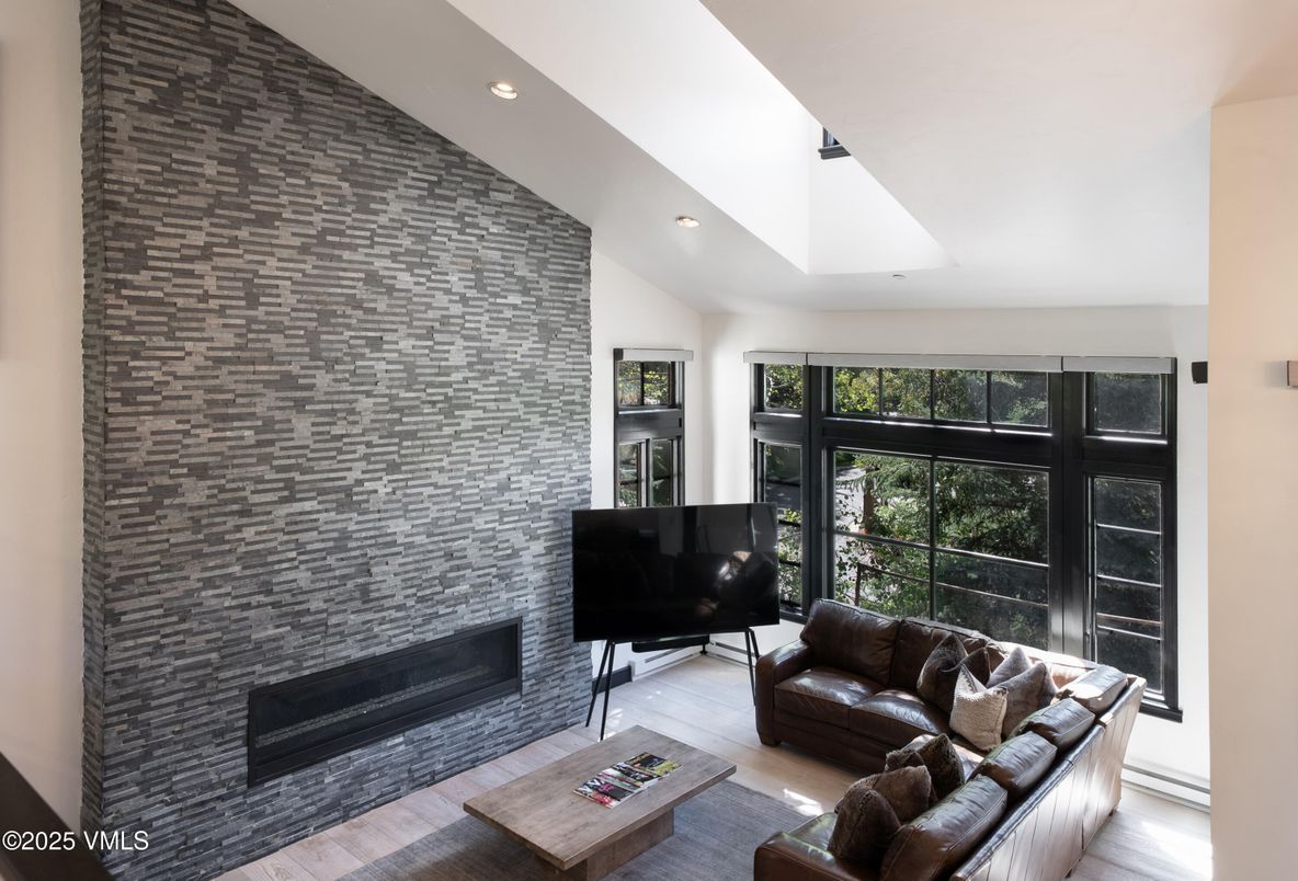 Fireplace, Interior, Living room, Recessed Lighting, Stone Walls, Wood Texture Flooring