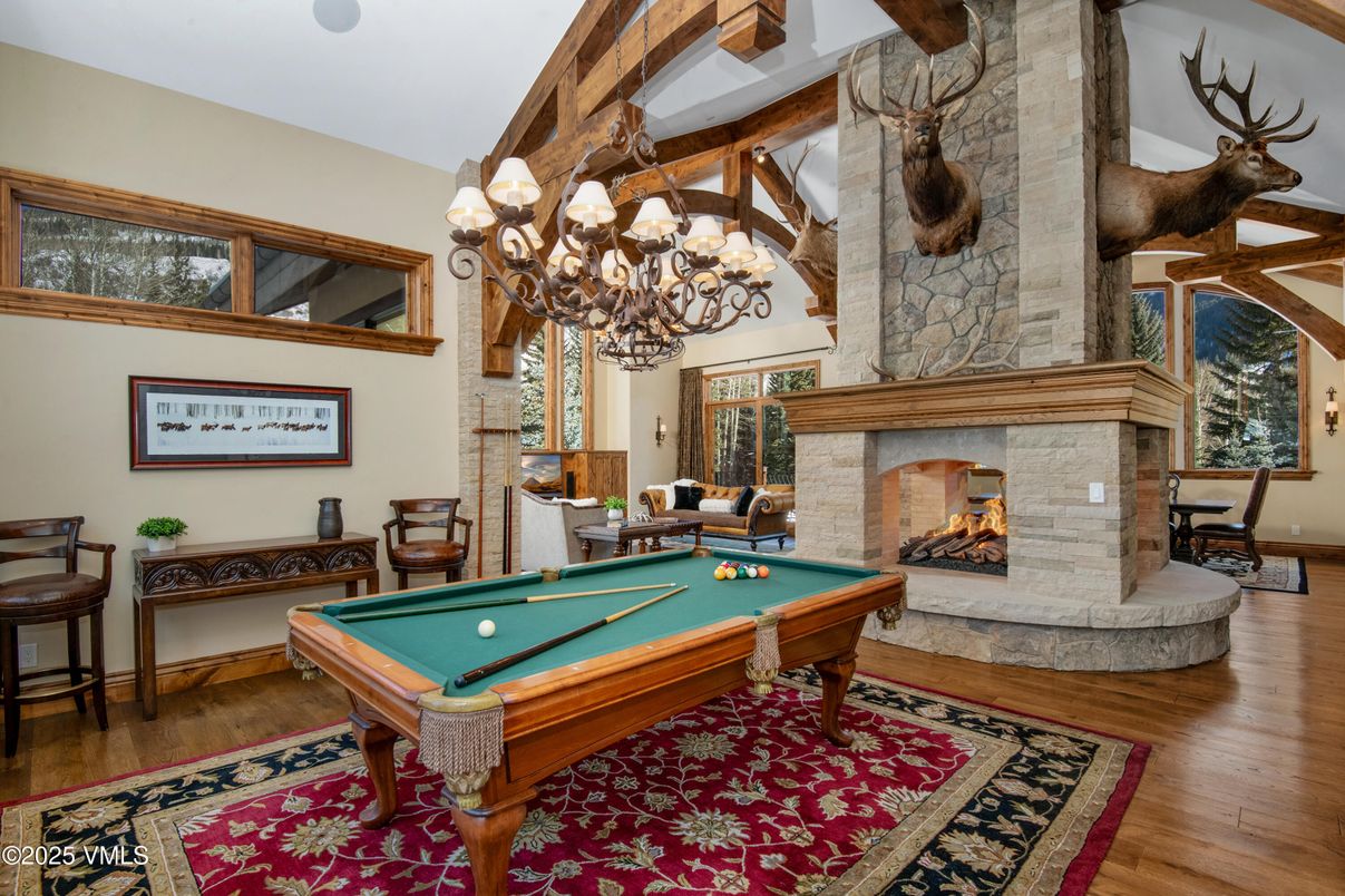 Billiard Table, Chandelier, Fireplace, Game Room, Interior, Stone Walls, Wood Texture Flooring