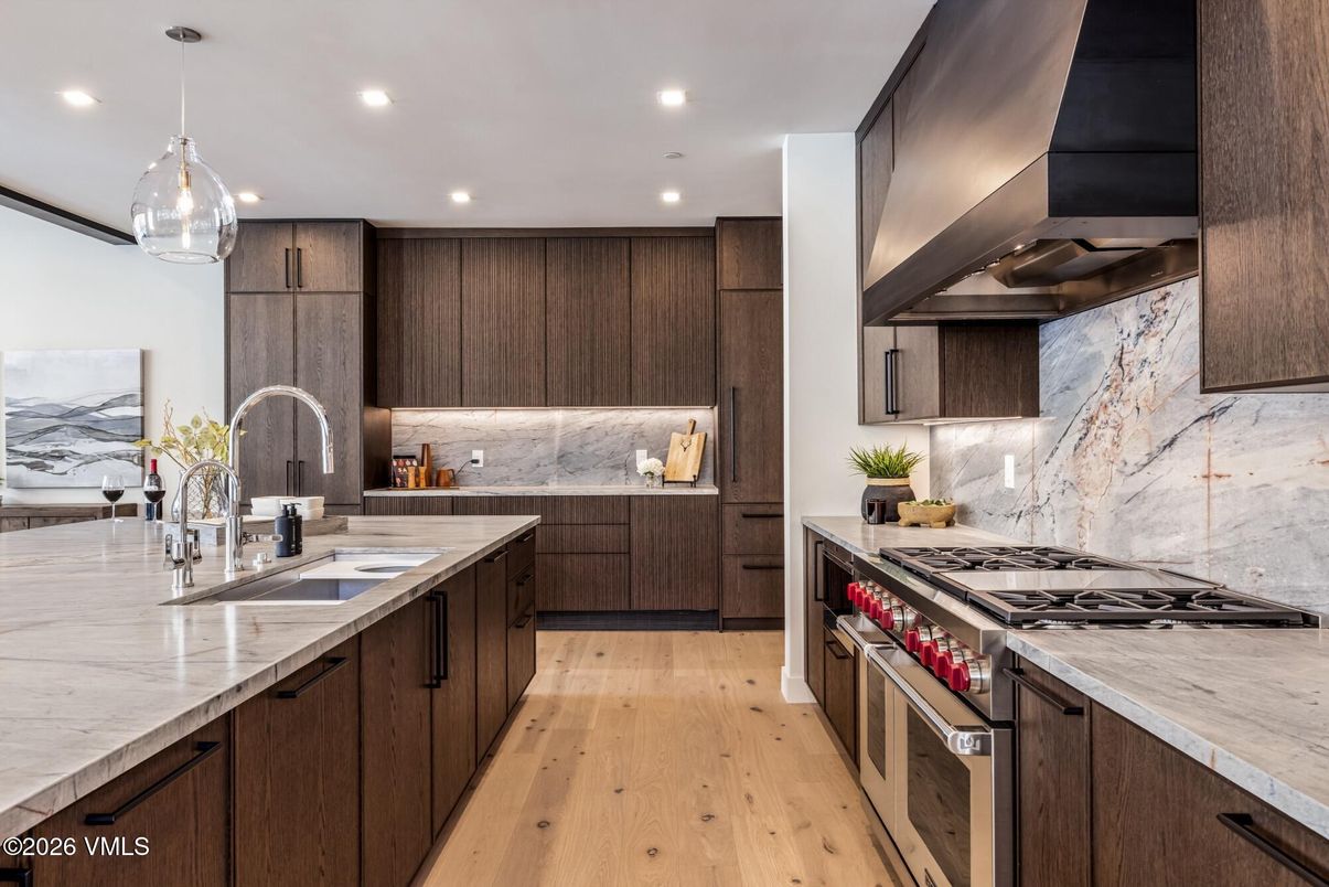 Interior, Kitchen, Marble Walls, Pendant Lights, Recessed Lighting, Stainless Steel Appliances, Wood Texture Flooring