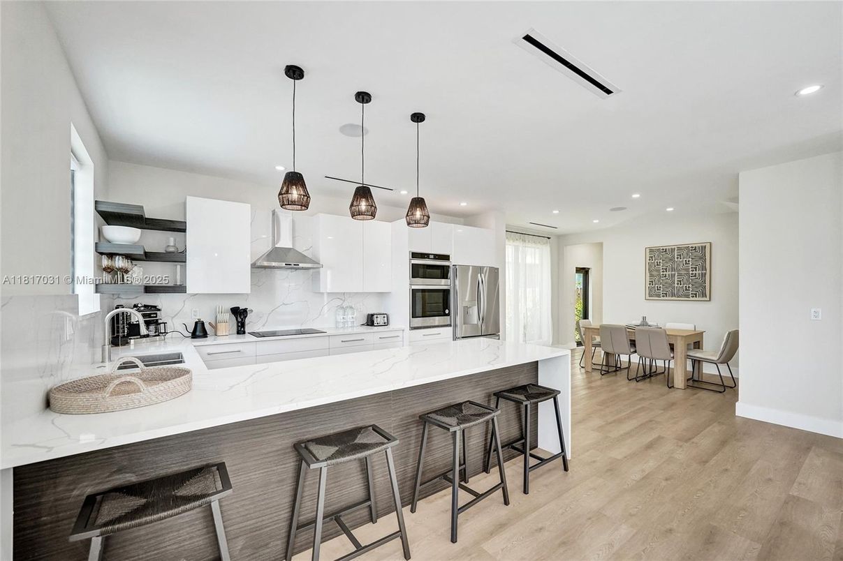 Dining room, Interior, Kitchen, Pendant Lights, Recessed Lighting, Stainless Steel Appliances, Wood Texture Flooring