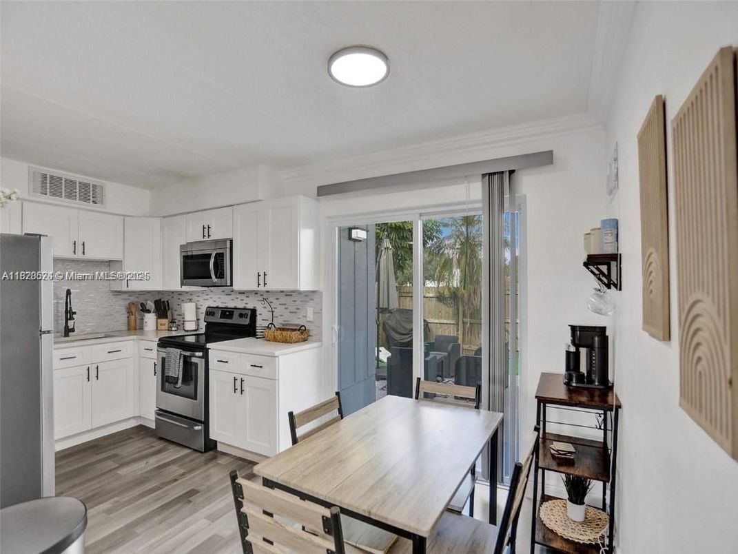 Dining room, Interior, Kitchen, Recessed Lighting, Stainless Steel Appliances, Wood Texture Flooring