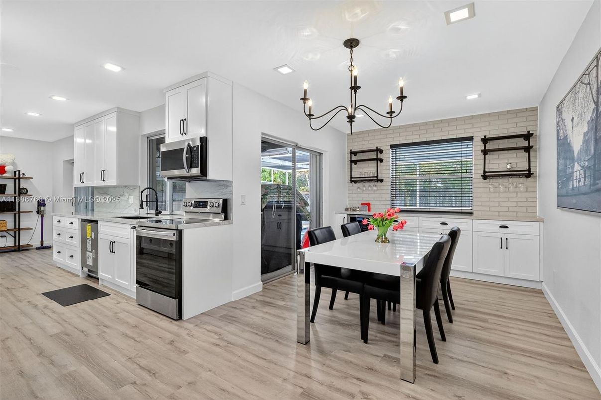 Chandelier, Dining room, Interior, Kitchen, Recessed Lighting, Stainless Steel Appliances, Wood Texture Flooring