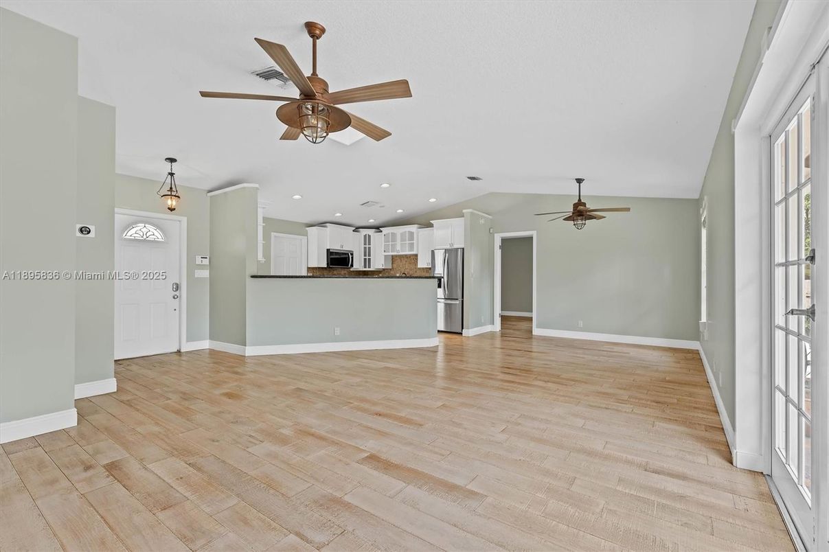 Empty room, Interior, Kitchen, Pendant Lights, Recessed Lighting, Stainless Steel Appliances, Wood Texture Flooring