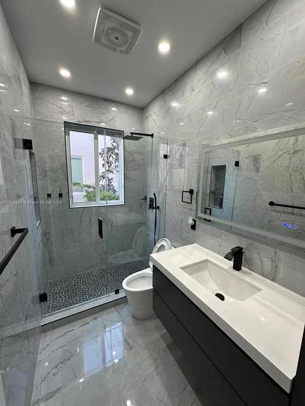 Bathroom, Dual Sink Vanities, Glass Shower, Interior, Marble, Marble Walls, Recessed Lighting