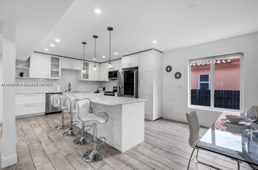 Dining room, Interior, Kitchen, Pendant Lights, Recessed Lighting, Stainless Steel Appliances, Wood Texture Flooring